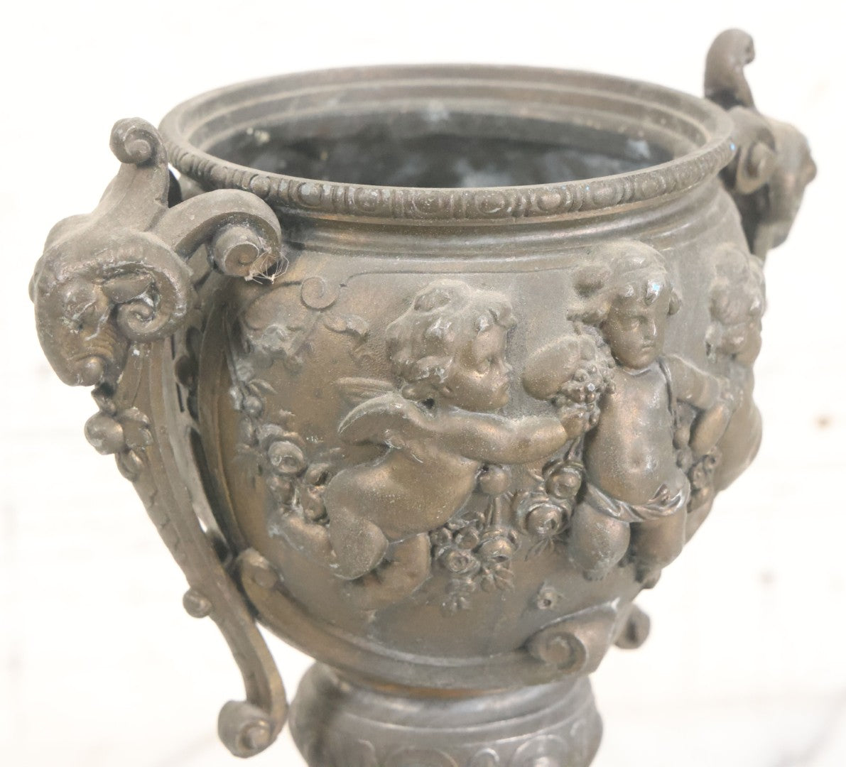 Lot 010 - Antique Ornate Cast Pot Metal Urn With Cherub And Goat Head Motifs, With Makers Mark On Bottom, Marked No. 1409, 9-1/2" High