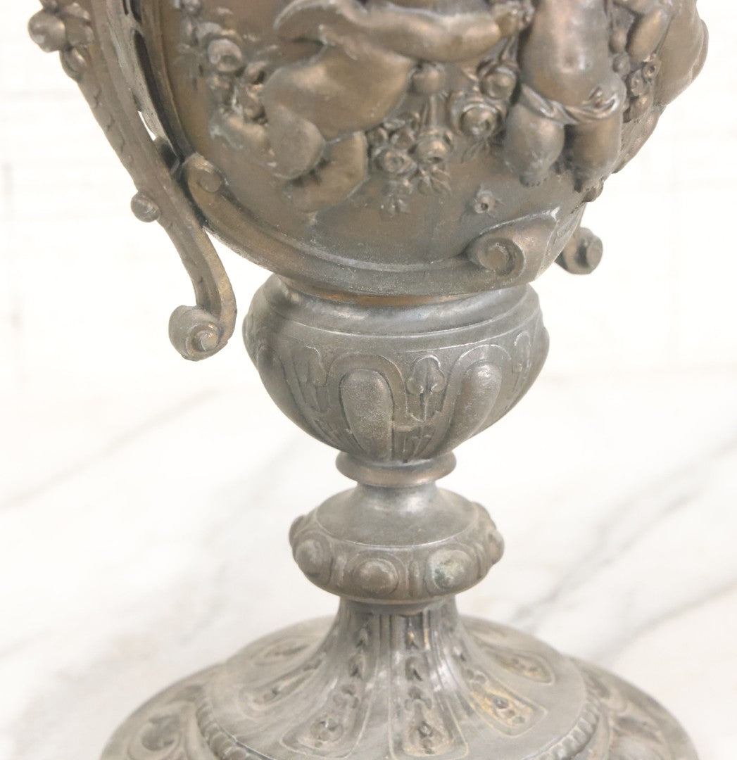 Lot 010 - Antique Ornate Cast Pot Metal Urn With Cherub And Goat Head Motifs, With Makers Mark On Bottom, Marked No. 1409, 9-1/2" High