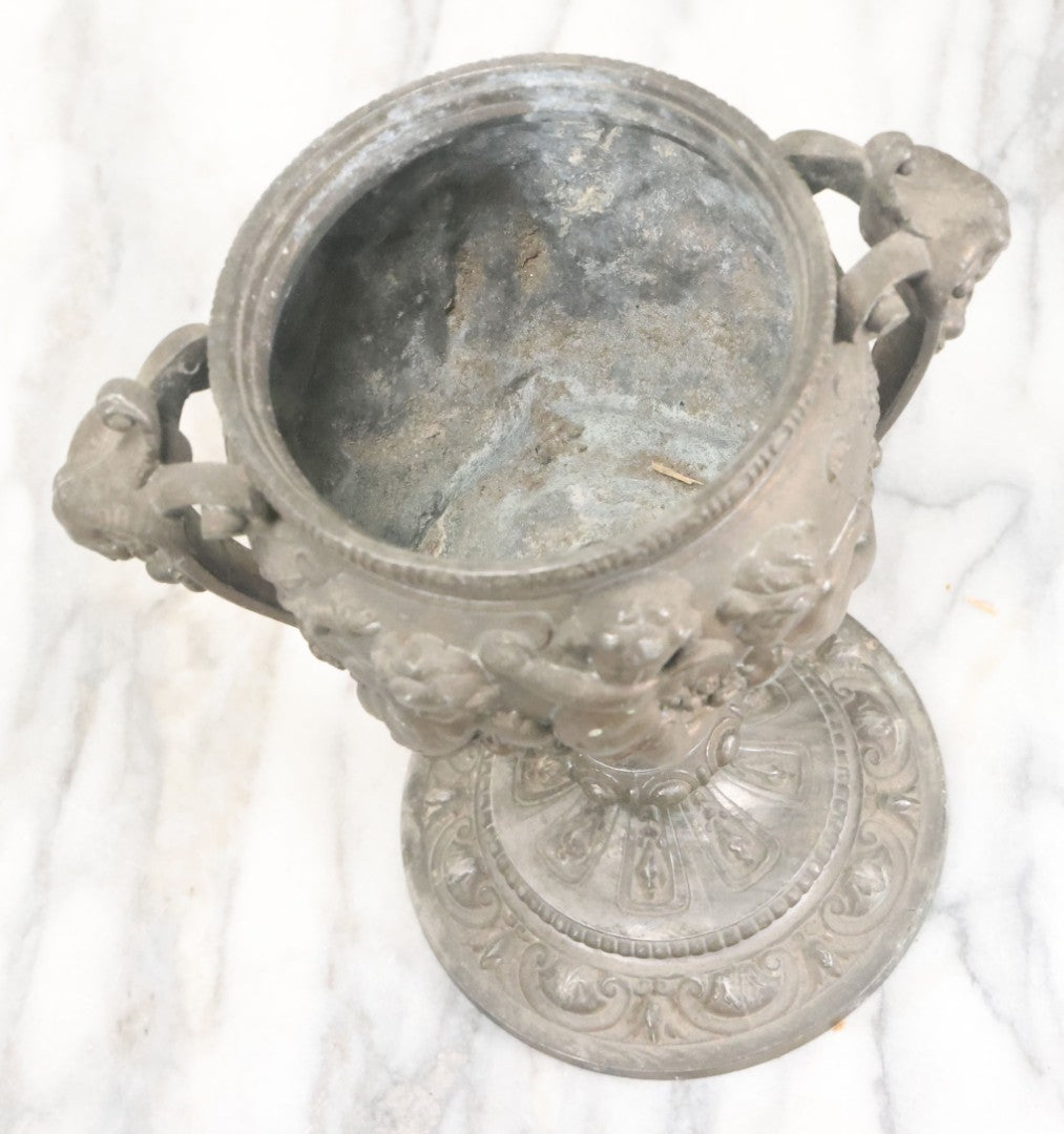 Lot 010 - Antique Ornate Cast Pot Metal Urn With Cherub And Goat Head Motifs, With Makers Mark On Bottom, Marked No. 1409, 9-1/2" High