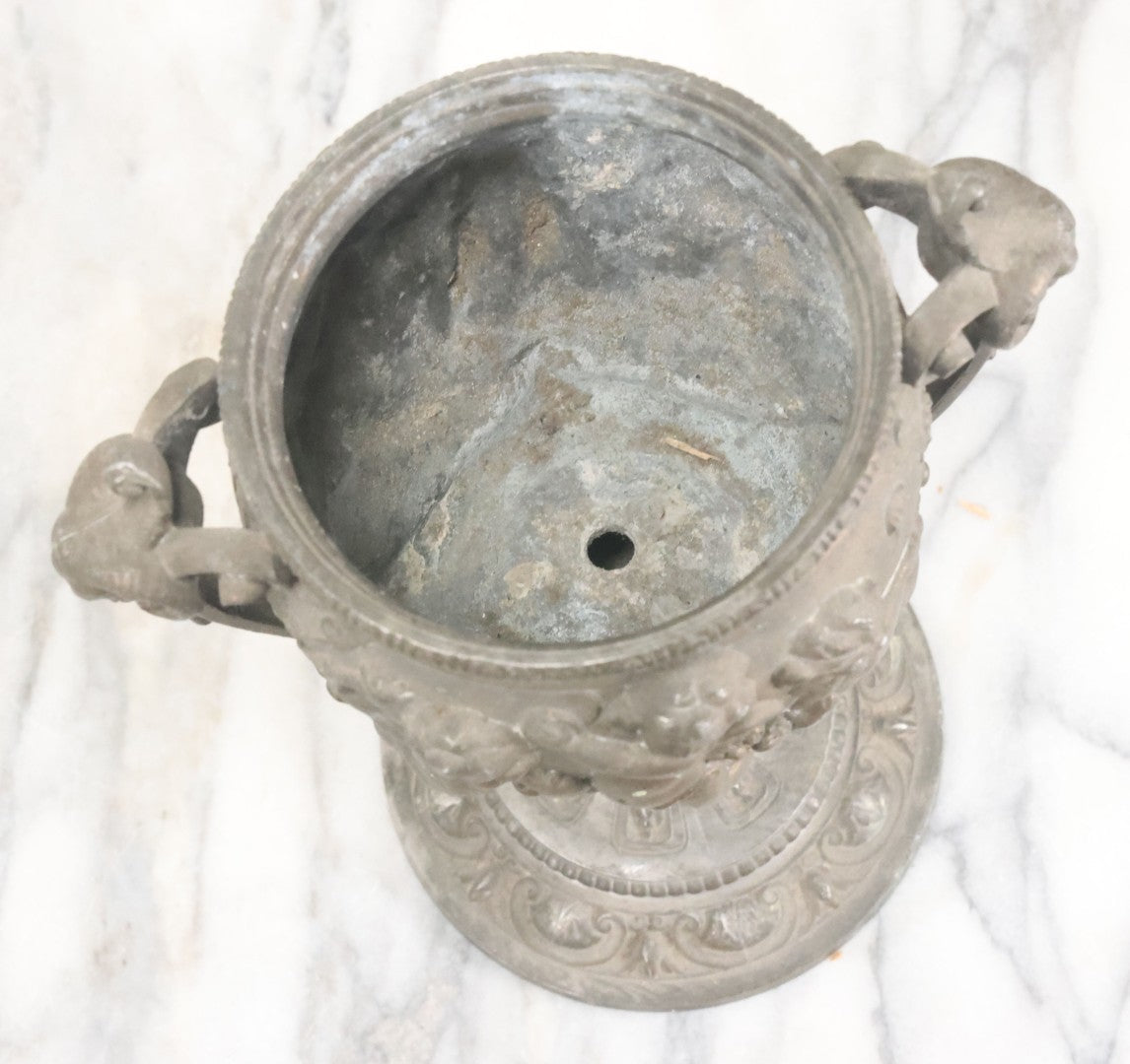 Lot 010 - Antique Ornate Cast Pot Metal Urn With Cherub And Goat Head Motifs, With Makers Mark On Bottom, Marked No. 1409, 9-1/2" High