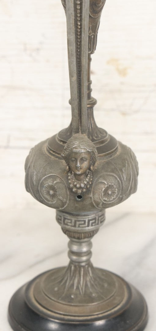 Lot 011 - Pair Of Antique Ornate Cast Pot Metal Ewers, With Woman's Head On Handle, And Woman's Head In Profile, Greek Key Design, Note Crack In Handle And Crack On Base Of One, 10-5/8" High Each