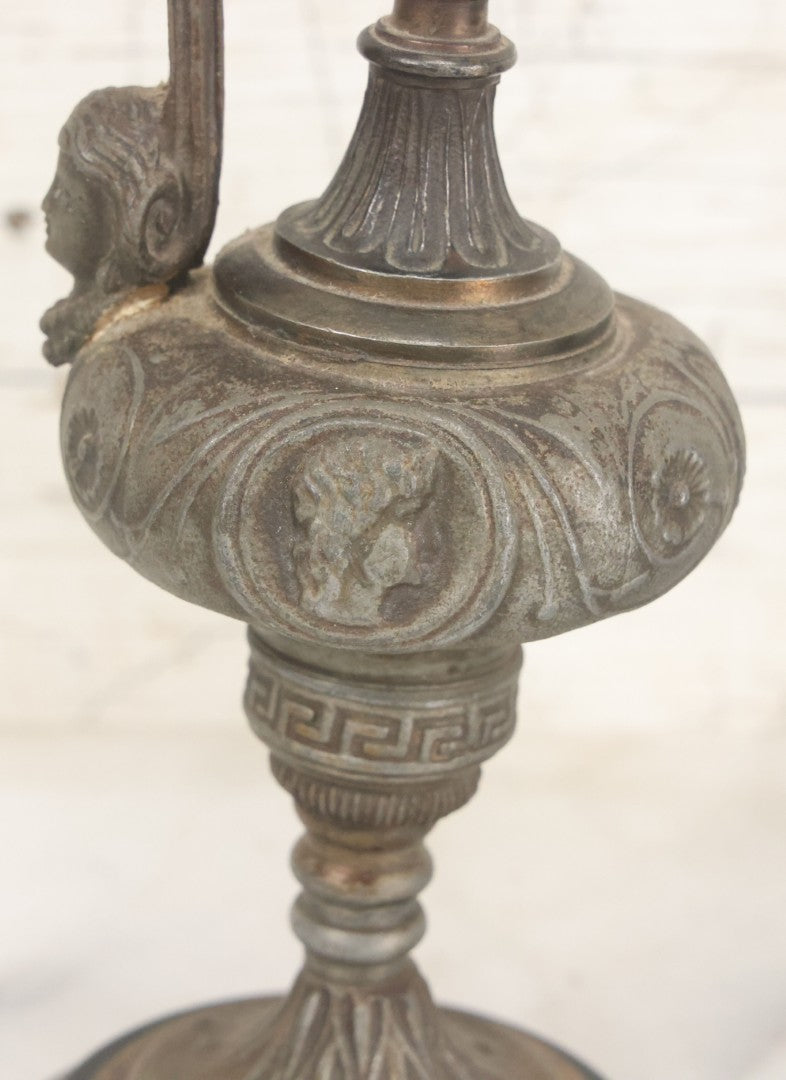 Lot 011 - Pair Of Antique Ornate Cast Pot Metal Ewers, With Woman's Head On Handle, And Woman's Head In Profile, Greek Key Design, Note Crack In Handle And Crack On Base Of One, 10-5/8" High Each