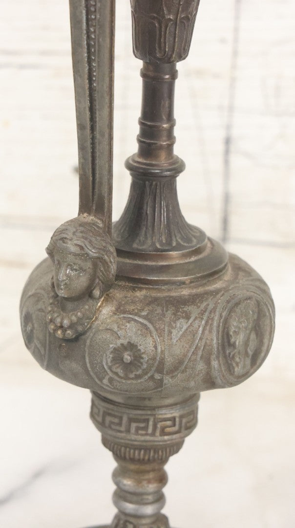 Lot 011 - Pair Of Antique Ornate Cast Pot Metal Ewers, With Woman's Head On Handle, And Woman's Head In Profile, Greek Key Design, Note Crack In Handle And Crack On Base Of One, 10-5/8" High Each