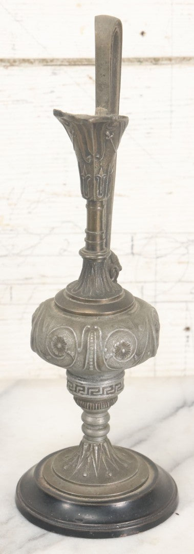 Lot 011 - Pair Of Antique Ornate Cast Pot Metal Ewers, With Woman's Head On Handle, And Woman's Head In Profile, Greek Key Design, Note Crack In Handle And Crack On Base Of One, 10-5/8" High Each