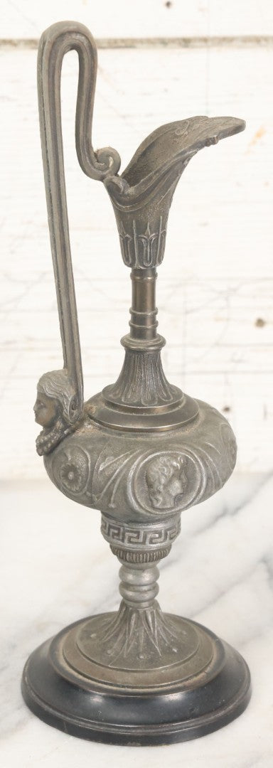Lot 011 - Pair Of Antique Ornate Cast Pot Metal Ewers, With Woman's Head On Handle, And Woman's Head In Profile, Greek Key Design, Note Crack In Handle And Crack On Base Of One, 10-5/8" High Each