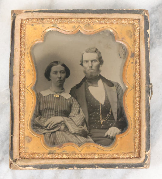 Lot 056 - Antique 1/6th Plate Ambrotype Photograph Of Young Couple Including Man With Messy Beard, Both With Gold-Tinted Jewelry, In Split Half Leatherette Union Case
