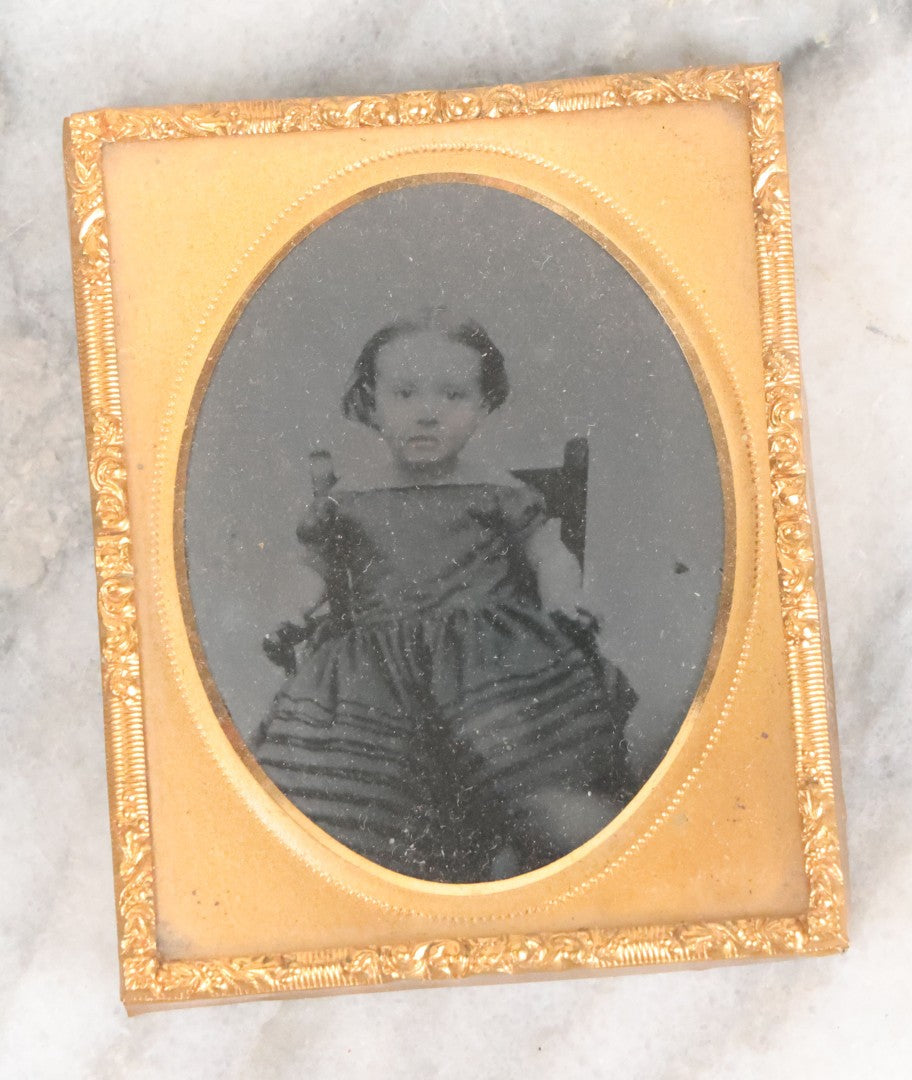 Lot 059 - Antique 1/9th Plate Ruby Ambrotype Photograph Of Young Girl Toddler With Off Shoulders Dress In Child's Armchair Clutching Chair Arms, Note Underexposure, Uncased