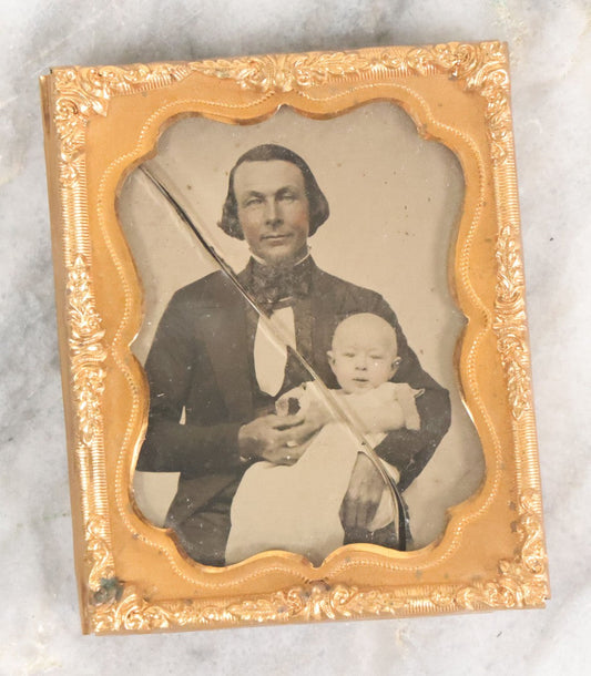 Lot 062 - Antique 1/9th Plate Ambrotype Photograph Of Young Smiling Father And Infant Child, Note Large Diagonal Crack Through Ambrotype, Uncased, Poor Condition