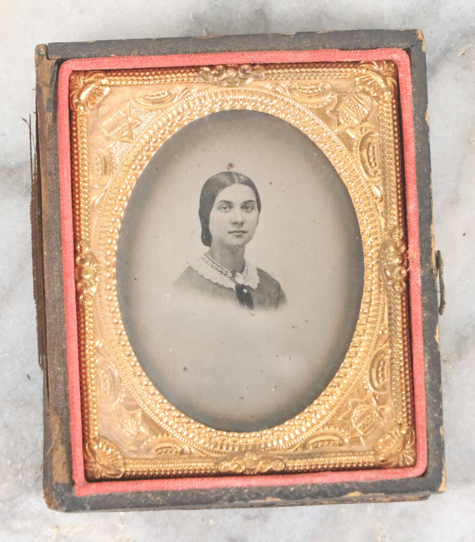 Lot 063 - Antique 1/9th Plate Tintype Photograph Of Pretty Young Woman Wearing Lace Collar And Cameo Brooch With Silvertone Background In Half Leatherette Union Case