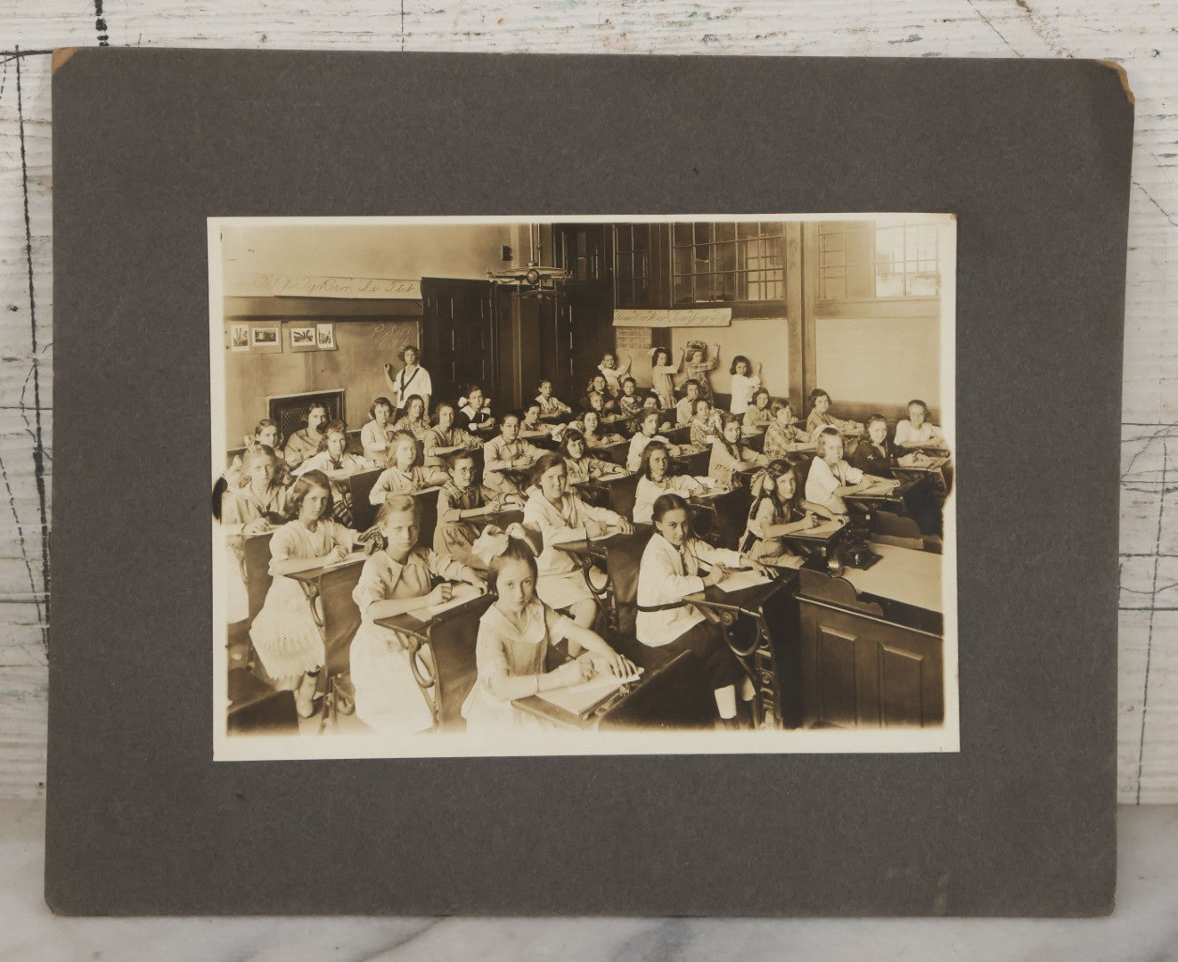Lot 067 - Antique Boarded Interior Schoolroom Photograph Of Class Of Girls And Their Teacher (6th Grade), April 29, 1921, Partial Identification On Verso