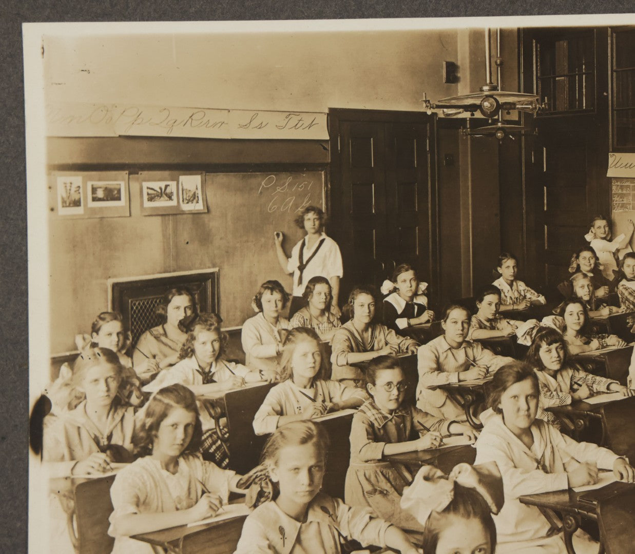Lot 067 - Antique Boarded Interior Schoolroom Photograph Of Class Of Girls And Their Teacher (6th Grade), April 29, 1921, Partial Identification On Verso