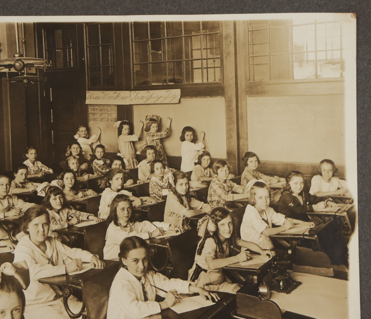 Lot 067 - Antique Boarded Interior Schoolroom Photograph Of Class Of Girls And Their Teacher (6th Grade), April 29, 1921, Partial Identification On Verso