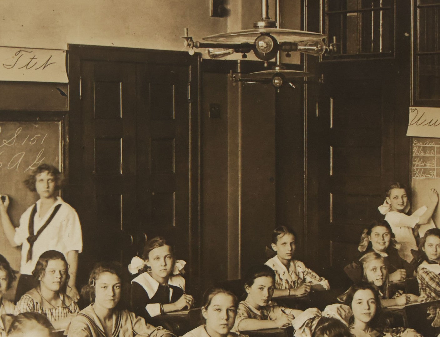 Lot 067 - Antique Boarded Interior Schoolroom Photograph Of Class Of Girls And Their Teacher (6th Grade), April 29, 1921, Partial Identification On Verso