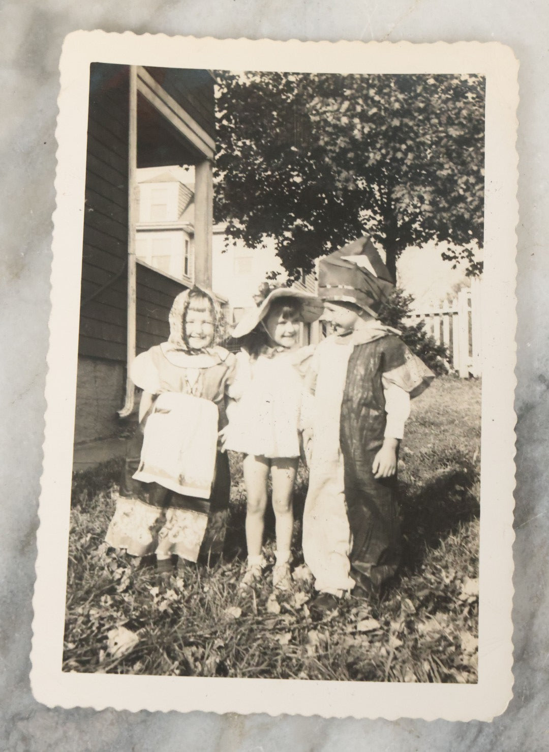 Lot 077 - Pair Of Vintage Snapshot Photographs Of 3 Children In Costume With Masks On Halloween, Circa 1944