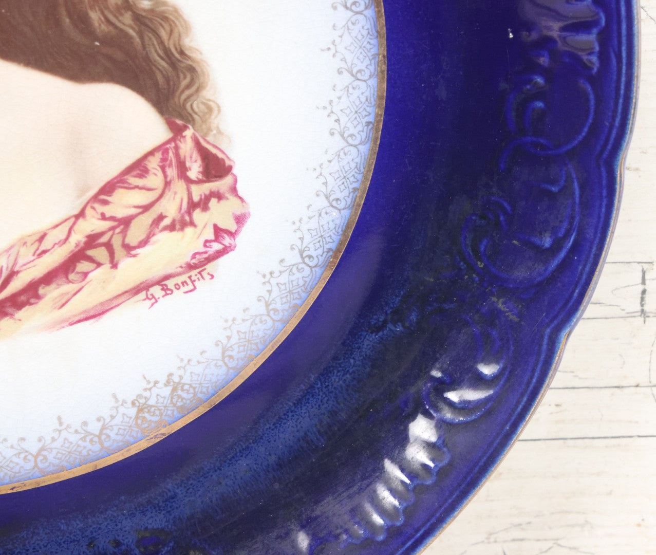 Lot 082 - Antique Decorative Transferware Plate With Blue Rim Featuring Pretty Woman With Long Brown Hair And Rose After G. Bonfits, By Royal La Belle, Wheeling Potteries Co., With Wire Hanger, 13" Diameter