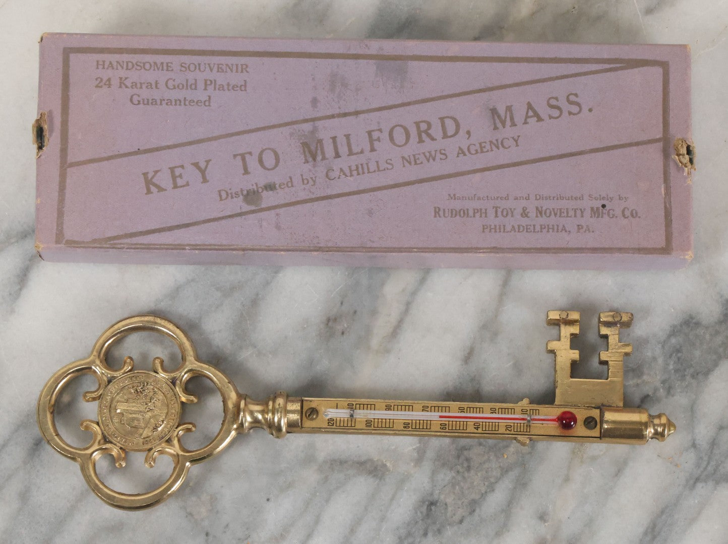 Lot 088 - Antique Brass Thermometer Key Souvenir, Key To Milford Massachusetts, Distributed By Cahills News Agency, Manufactured By Rudolph Toy & Novelty Co., Philadelphia, 24K Gold Plated, In Original Box
