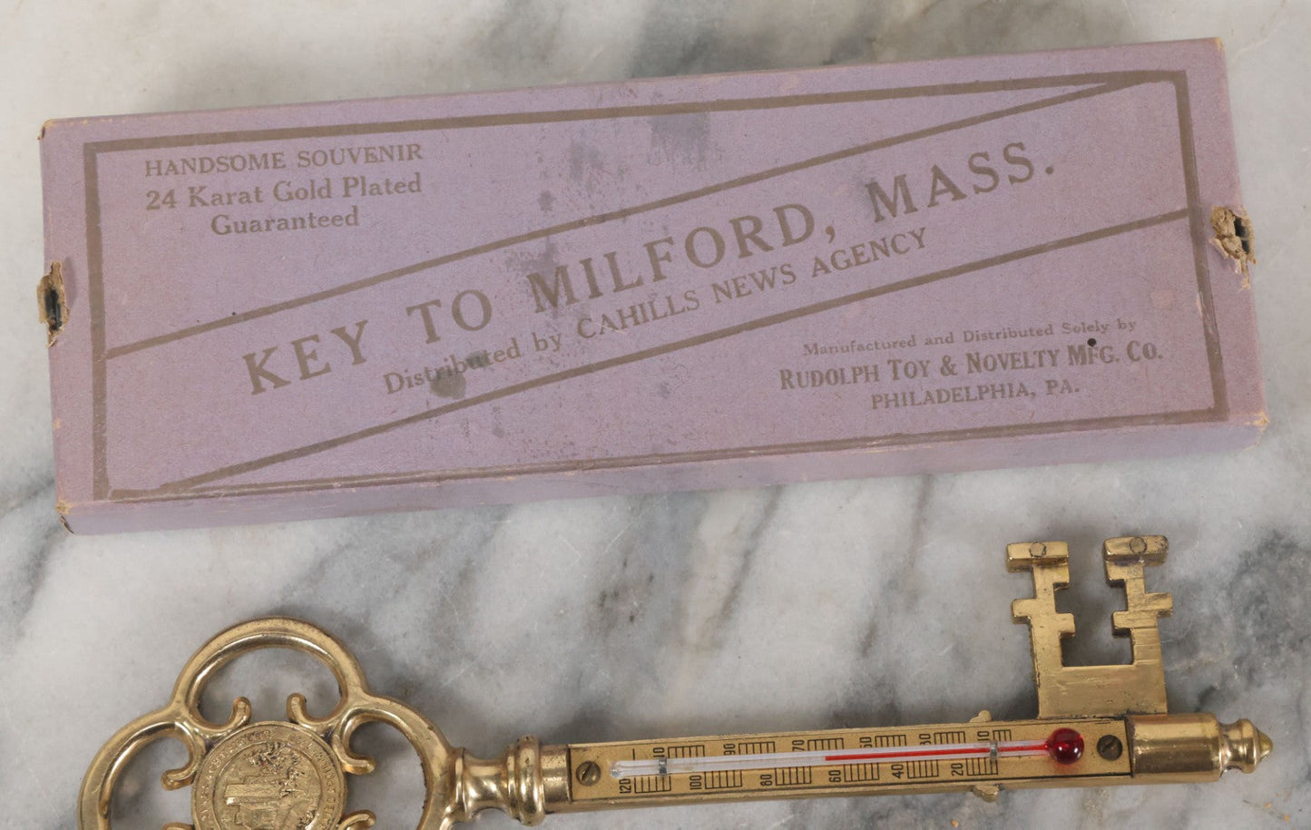 Lot 088 - Antique Brass Thermometer Key Souvenir, Key To Milford Massachusetts, Distributed By Cahills News Agency, Manufactured By Rudolph Toy & Novelty Co., Philadelphia, 24K Gold Plated, In Original Box