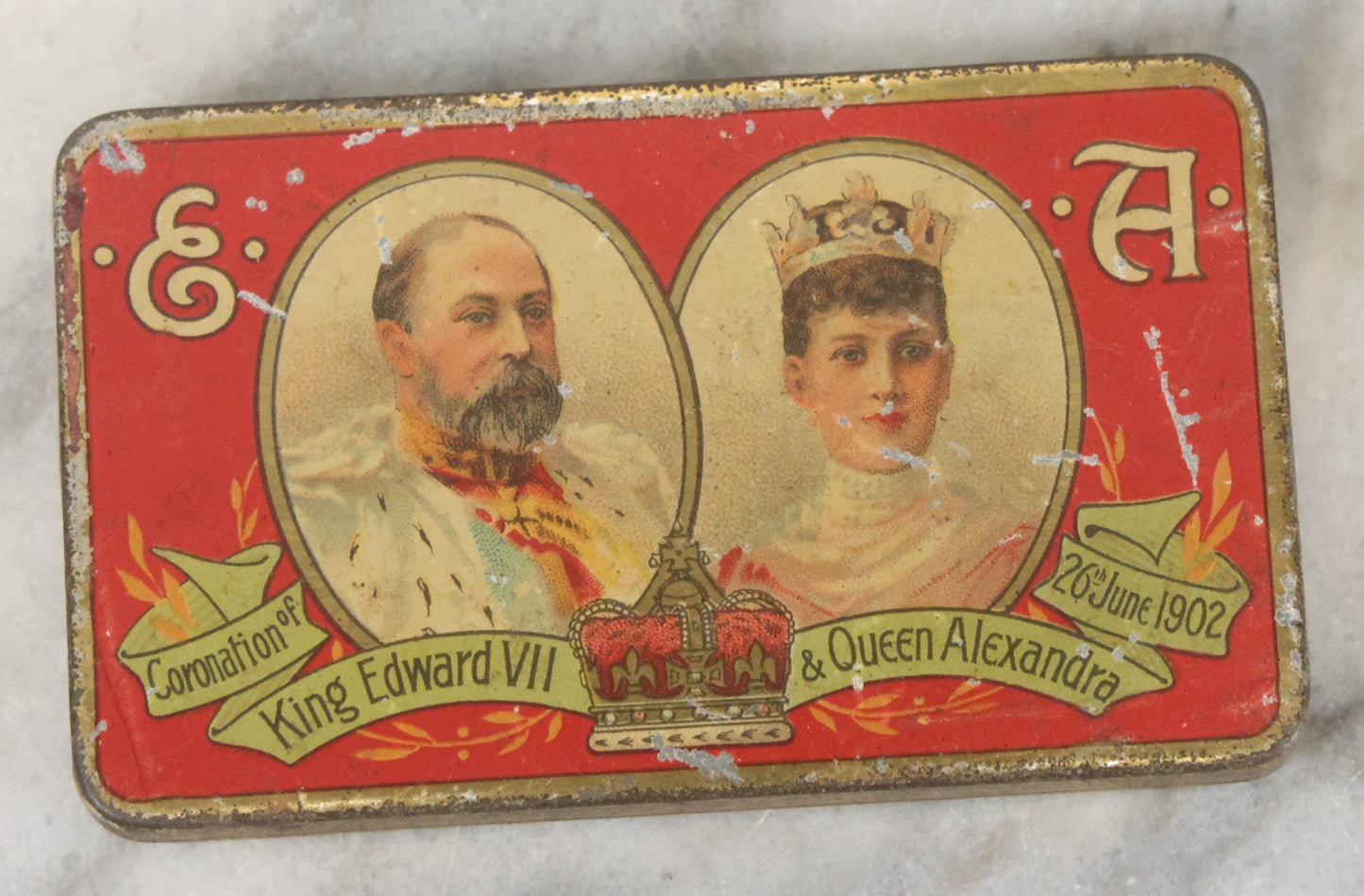 Lot 093 - Antique 5 Item Metals Grouping Including "Mother" Perfume Bottle Top, King Edward Vii & Queen Alexandra Commemorative Tin, Nude Woman Art Deco Fragment, First Birthday Pin, And Teaspoon