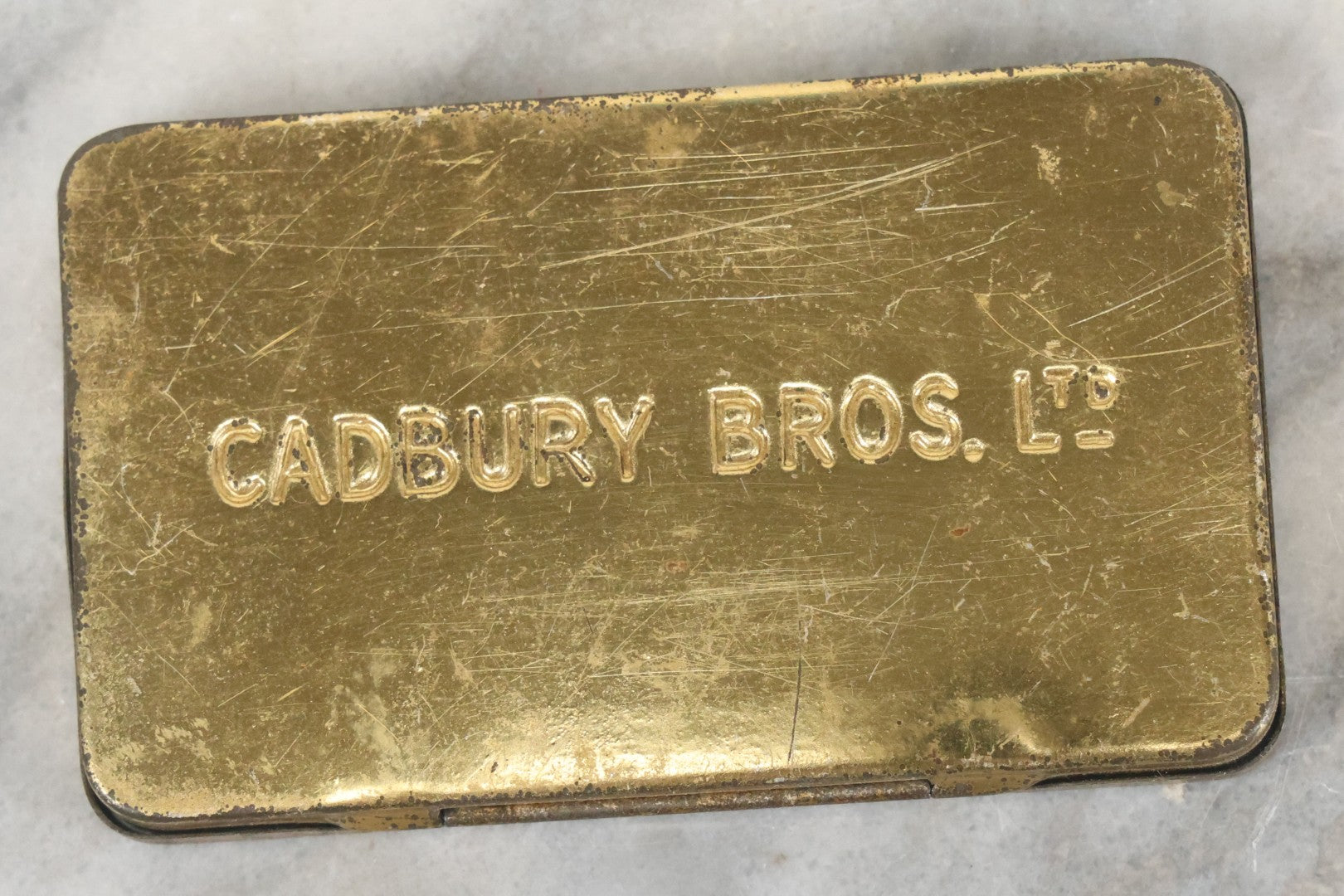 Lot 093 - Antique 5 Item Metals Grouping Including "Mother" Perfume Bottle Top, King Edward Vii & Queen Alexandra Commemorative Tin, Nude Woman Art Deco Fragment, First Birthday Pin, And Teaspoon
