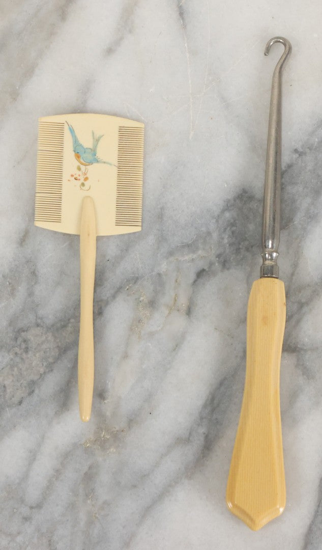 Lot 095 - Pair Of Antique Celluloid Dresser Items, Including Baby Comb With Painted Bluebird And Corset Hook