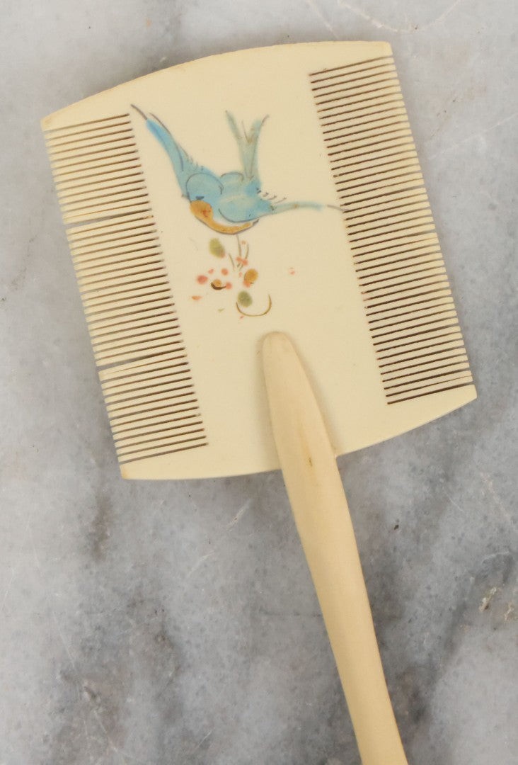 Lot 095 - Pair Of Antique Celluloid Dresser Items, Including Baby Comb With Painted Bluebird And Corset Hook