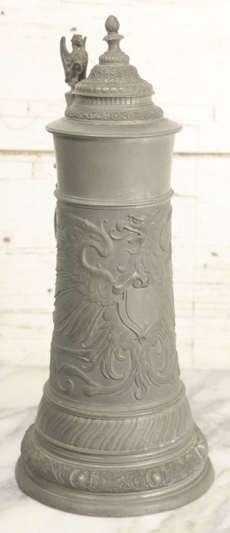 Lot 002 - Antique German Pewter Stein With Eagle, Griffin, And Cherub Motifs, Hinged Lid, Overall Height 14-1/4", Base 6-3/8" Diameter