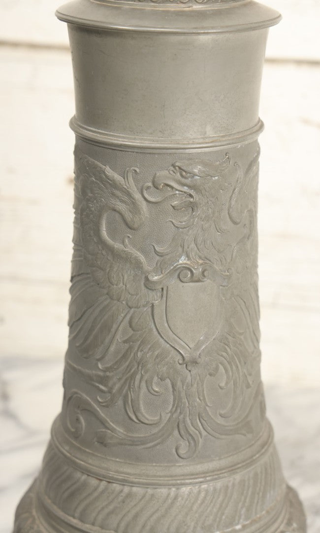 Lot 002 - Antique German Pewter Stein With Eagle, Griffin, And Cherub Motifs, Hinged Lid, Overall Height 14-1/4", Base 6-3/8" Diameter