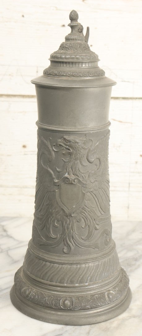 Lot 002 - Antique German Pewter Stein With Eagle, Griffin, And Cherub Motifs, Hinged Lid, Overall Height 14-1/4", Base 6-3/8" Diameter