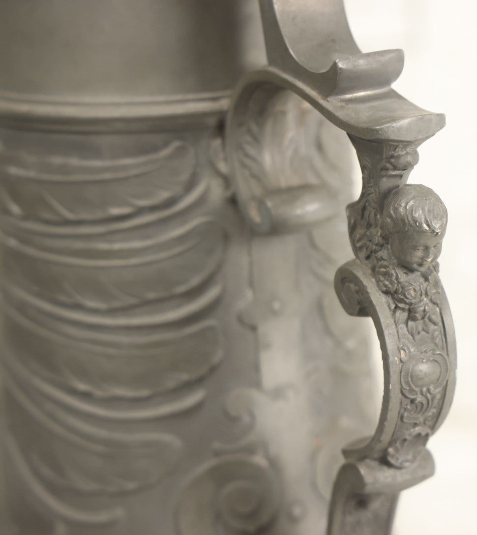 Lot 002 - Antique German Pewter Stein With Eagle, Griffin, And Cherub Motifs, Hinged Lid, Overall Height 14-1/4", Base 6-3/8" Diameter