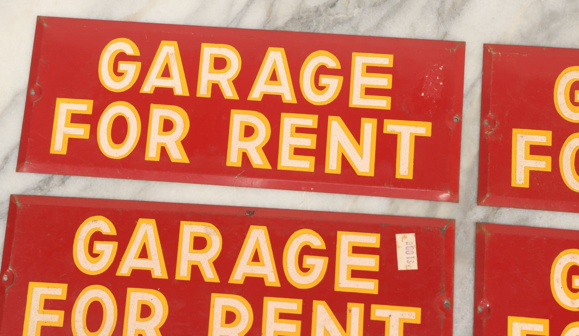 Lot 017 - Grouping Of Four Vintage Red "Garage For Rent" Tin Tacker Sign With Smaltz Lettering, White Letters With Yellow Outlines, 9-1/4" x 3-1/2"