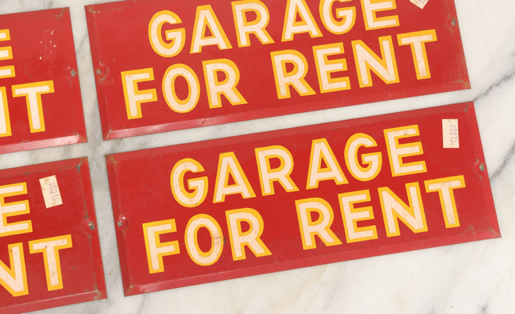 Lot 017 - Grouping Of Four Vintage Red "Garage For Rent" Tin Tacker Sign With Smaltz Lettering, White Letters With Yellow Outlines, 9-1/4" x 3-1/2"