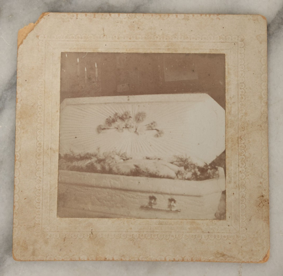Lot 050 - Antique Boarded Photograph Of An Open Casket Funeral With A White Coffin, Corpse Not Visible, Identified On Verso As Mable McCloud