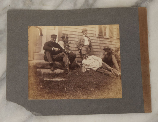 Lot 053 - Antique Boarded Photograph Of Fishermen, Hunters Smoking Pipes On The Stoop Of A House, With Hunting Dog Beagle In Photo
