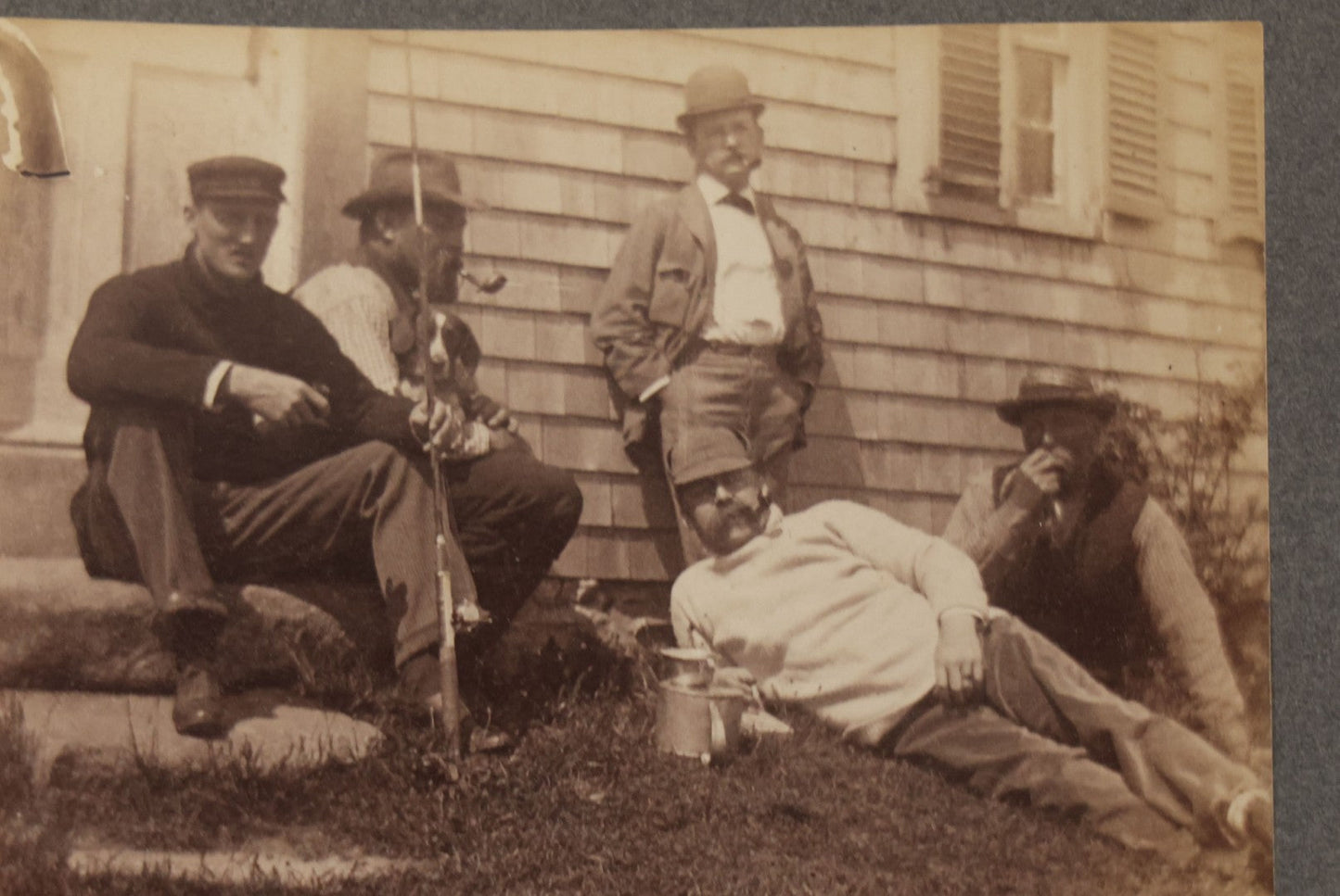 Lot 053 - Antique Boarded Photograph Of Fishermen, Hunters Smoking Pipes On The Stoop Of A House, With Hunting Dog Beagle In Photo