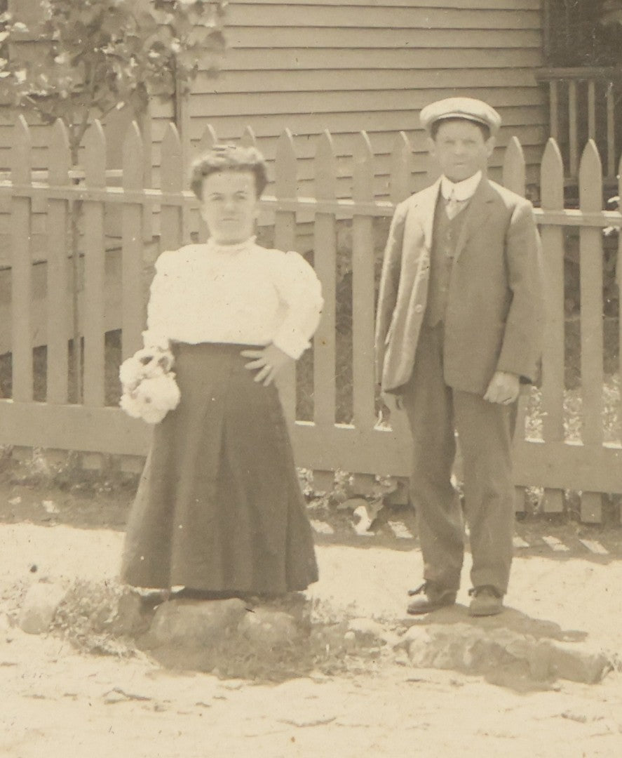 Lot 055 - Antique Boarded Photograph Of A Couple With Dwarfism Posing Outside Of A House / General Store With A Sign Reading "Confectionary, Tonics, Cigars, And Tobacco"