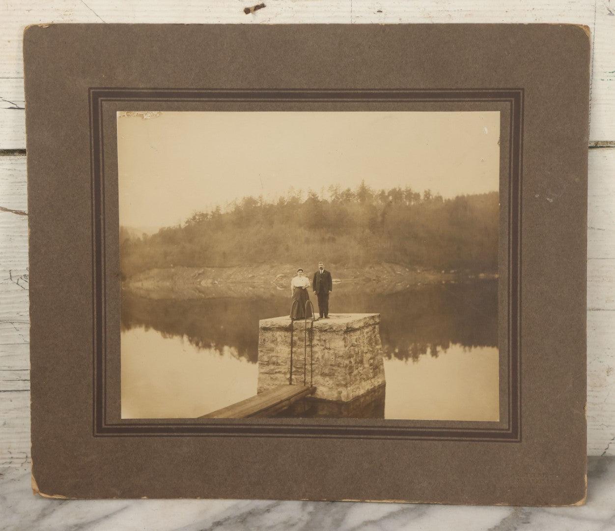Lot 057 - Antique Boarded Photograph Of A Man And Woman Posing On A Dam
