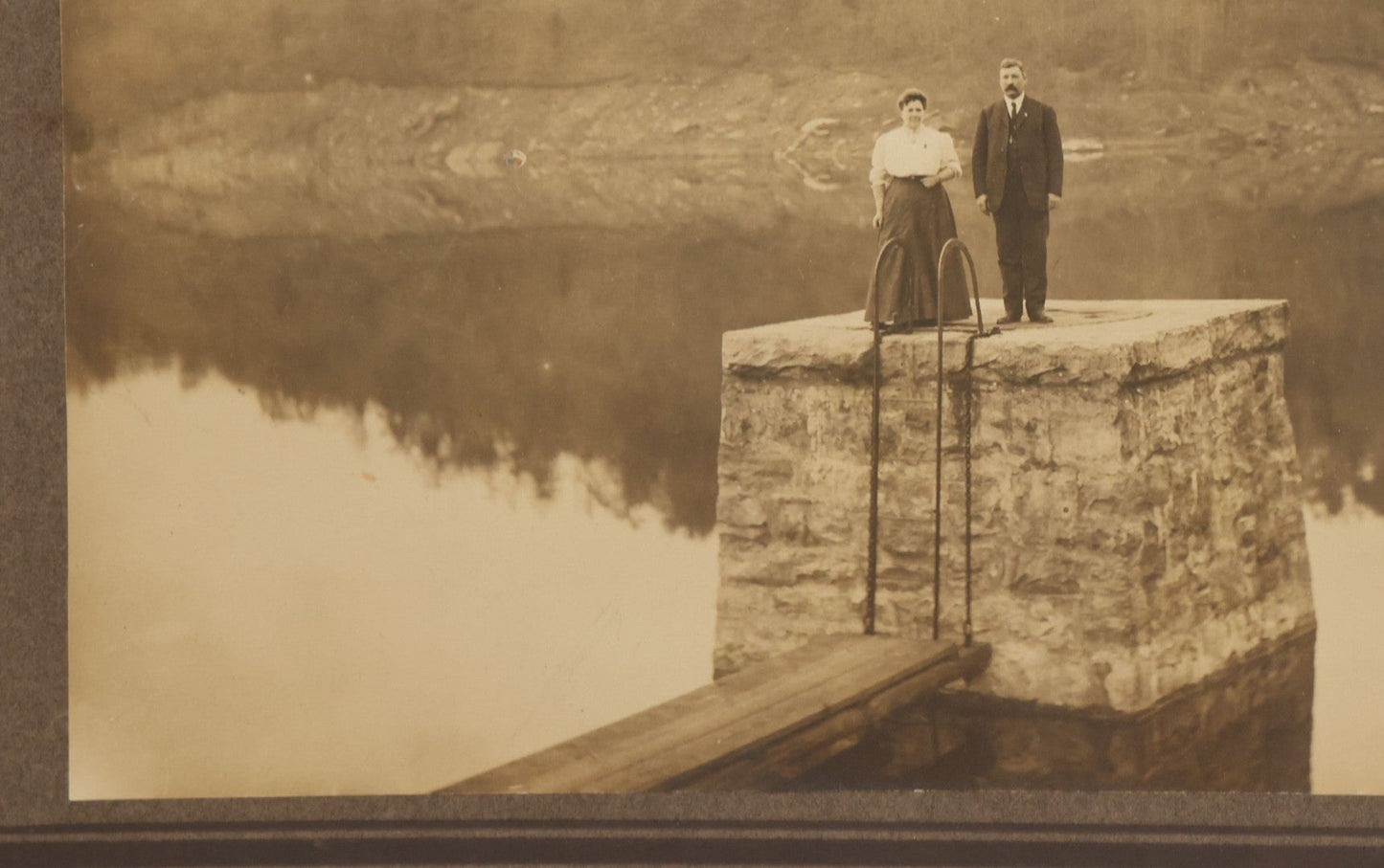 Lot 057 - Antique Boarded Photograph Of A Man And Woman Posing On A Dam