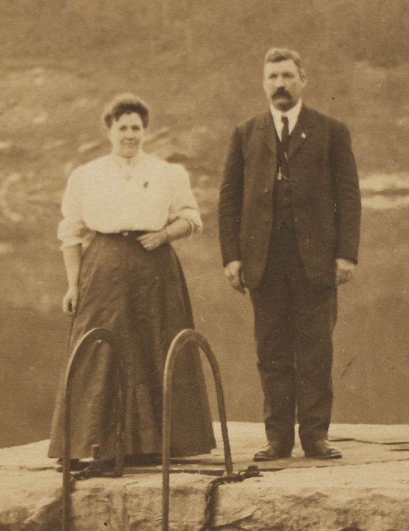 Lot 057 - Antique Boarded Photograph Of A Man And Woman Posing On A Dam