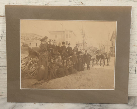 Lot 059 - Antique Boarded Photograph Of A Group Of Mostly Women Posing On A Long Horse Drawn Carriage. Shrink Wrapped With Mat