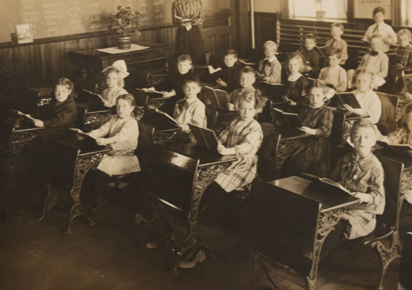 Lot 060 - Antique Boarded Photograph Of The Interior Of A 2Nd Grade Classroom With School Children, Teacher Holding Books,