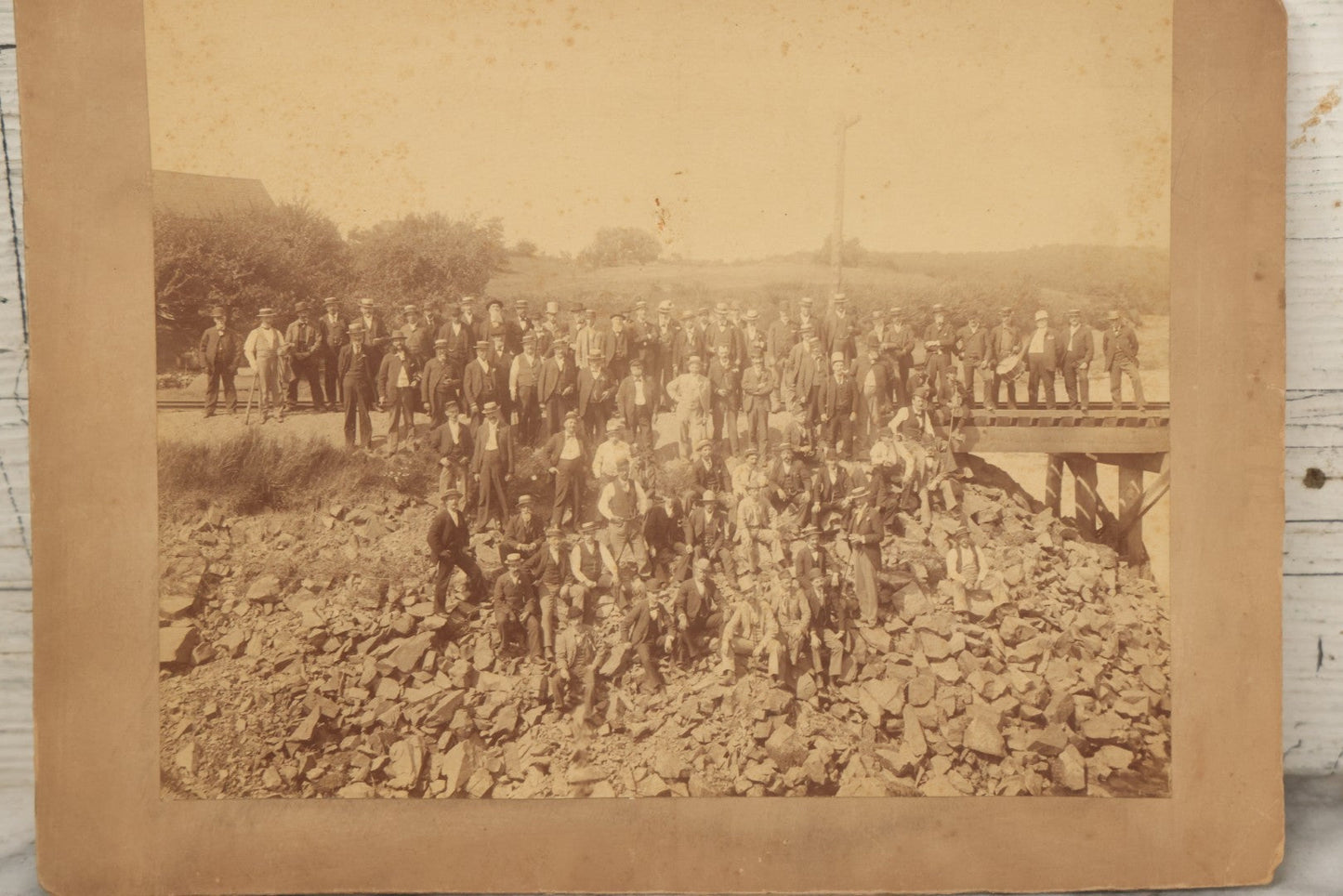 Lot 064 - Antique Photograph Of A Large Group Of Men Posing Next To The Dover Point Trestle Railroad Train Bridge, Dover, New Hampshire, With Detailed Identification On Verso, 1892