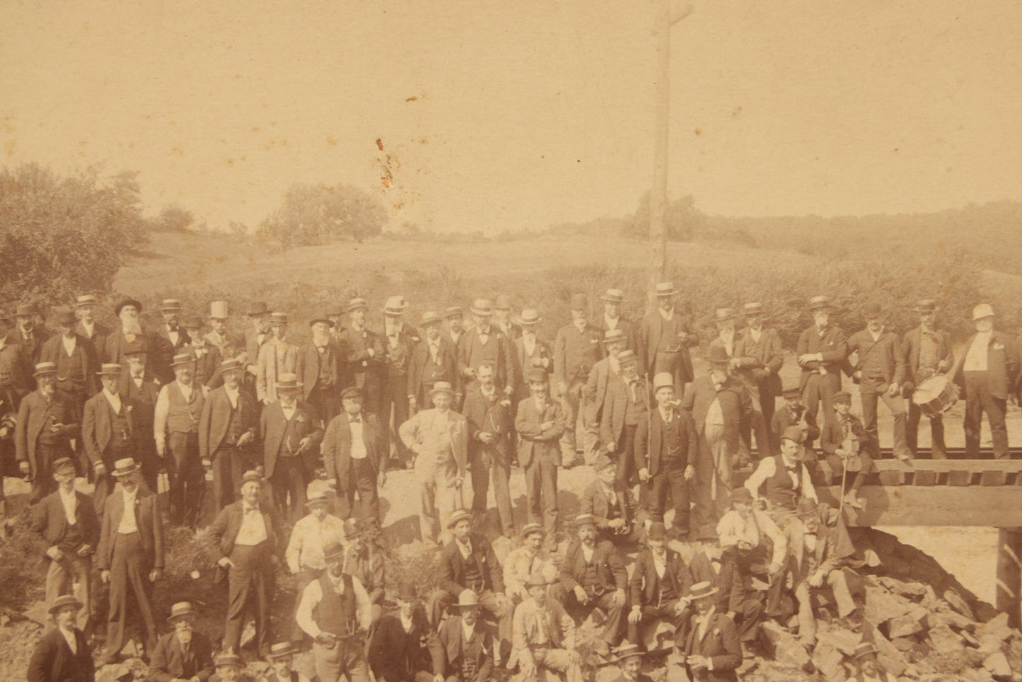 Lot 064 - Antique Photograph Of A Large Group Of Men Posing Next To The Dover Point Trestle Railroad Train Bridge, Dover, New Hampshire, With Detailed Identification On Verso, 1892
