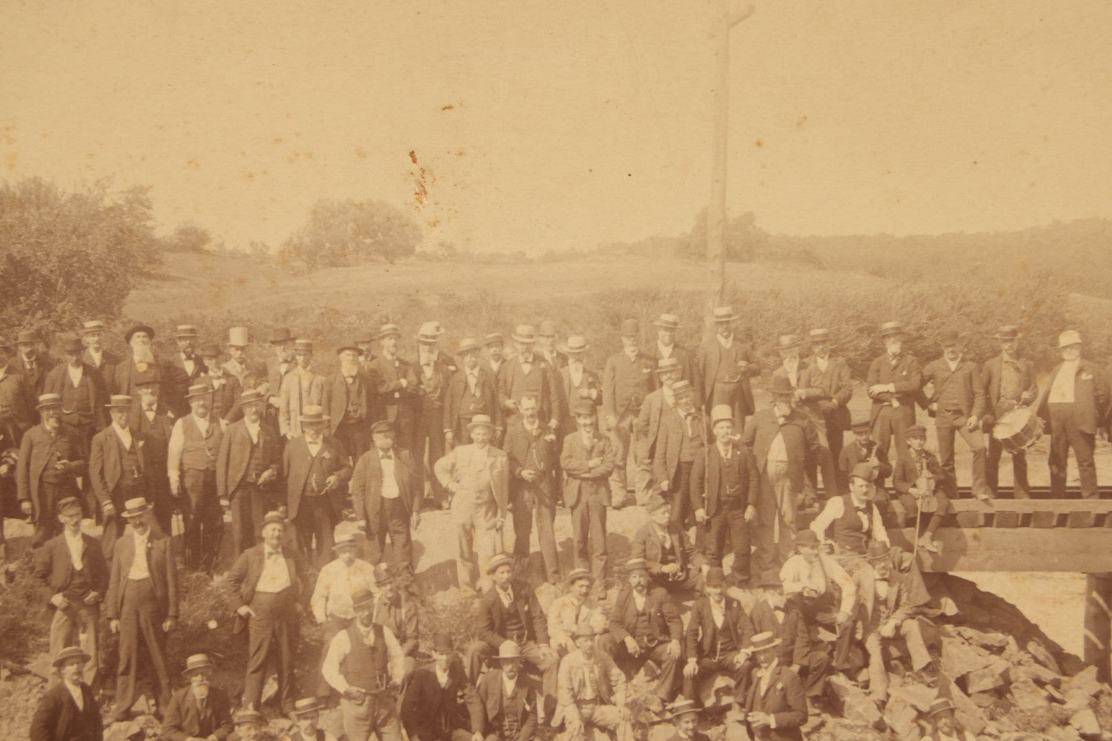 Lot 064 - Antique Photograph Of A Large Group Of Men Posing Next To The Dover Point Trestle Railroad Train Bridge, Dover, New Hampshire, With Detailed Identification On Verso, 1892