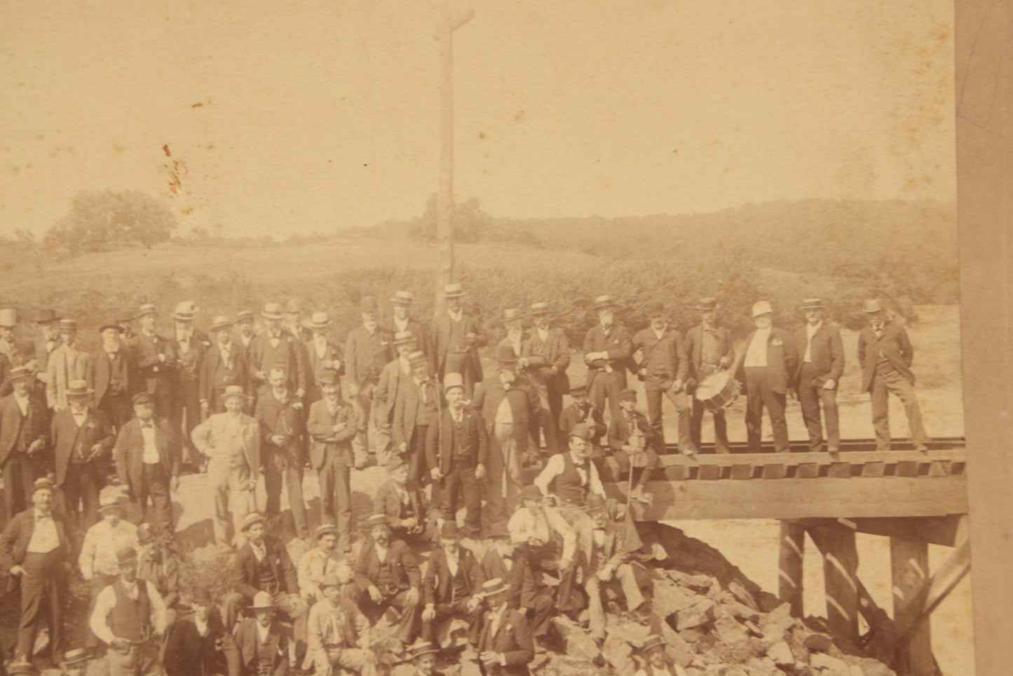 Lot 064 - Antique Photograph Of A Large Group Of Men Posing Next To The Dover Point Trestle Railroad Train Bridge, Dover, New Hampshire, With Detailed Identification On Verso, 1892