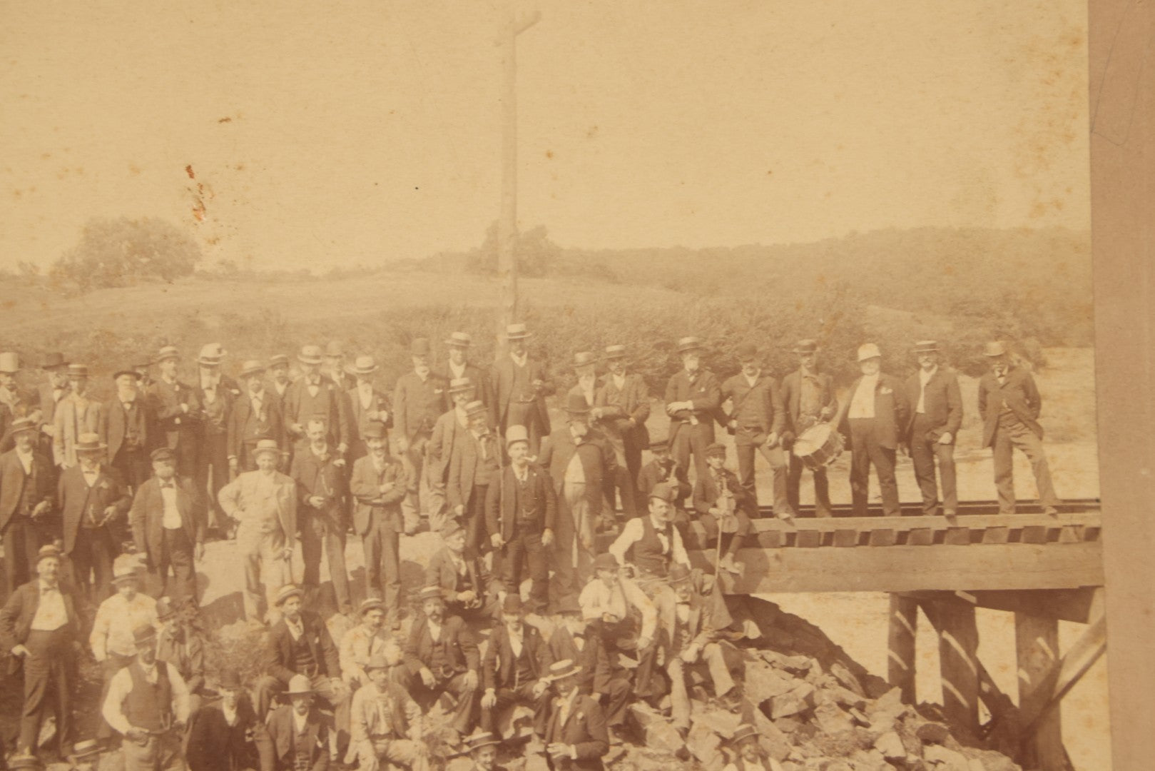 Lot 064 - Antique Photograph Of A Large Group Of Men Posing Next To The Dover Point Trestle Railroad Train Bridge, Dover, New Hampshire, With Detailed Identification On Verso, 1892