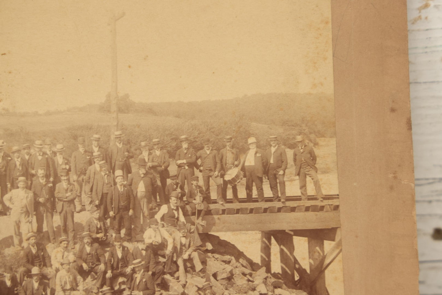 Lot 064 - Antique Photograph Of A Large Group Of Men Posing Next To The Dover Point Trestle Railroad Train Bridge, Dover, New Hampshire, With Detailed Identification On Verso, 1892