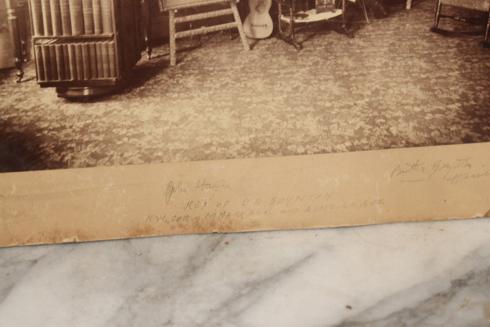 Lot 068 - Antique Boarded Interior Photograph Of The Living Room Of Charles And Elvira Boynton, With Photographs Of John Haines And Bertha Boynton Haines Displayed Along With Artwork, Instruments, Etc