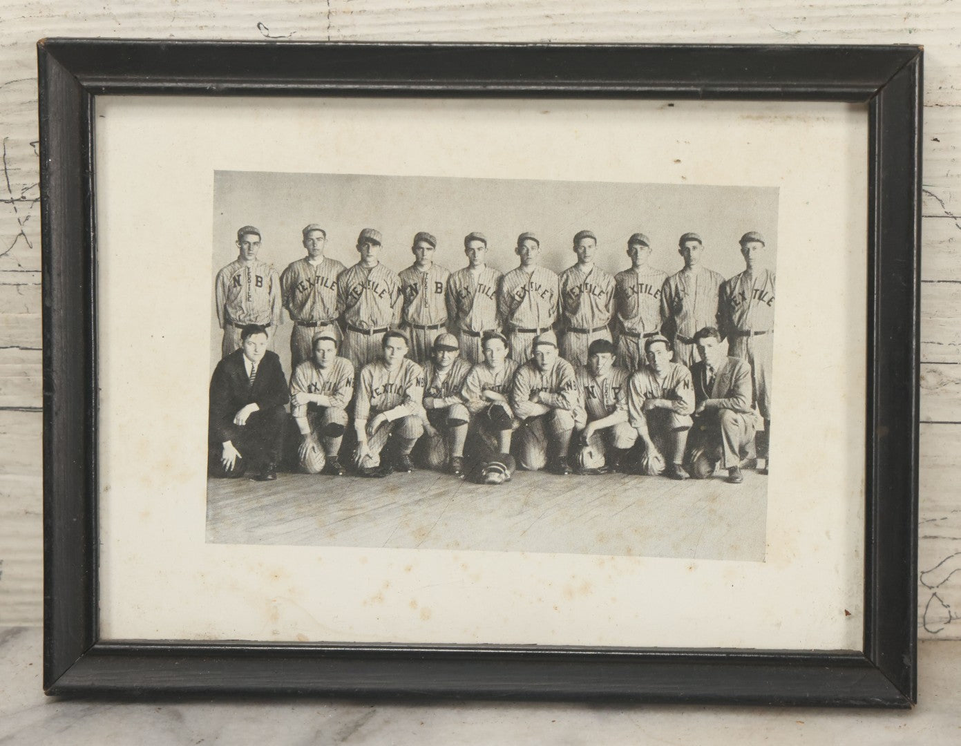 Lot 069 - Antique Framed Photograph Of A Baseball Team With Jerseys Marked "N.B. Textile" Likely Referring To New Bedford, Massachusetts, 7-3/4" x 5-7/8"