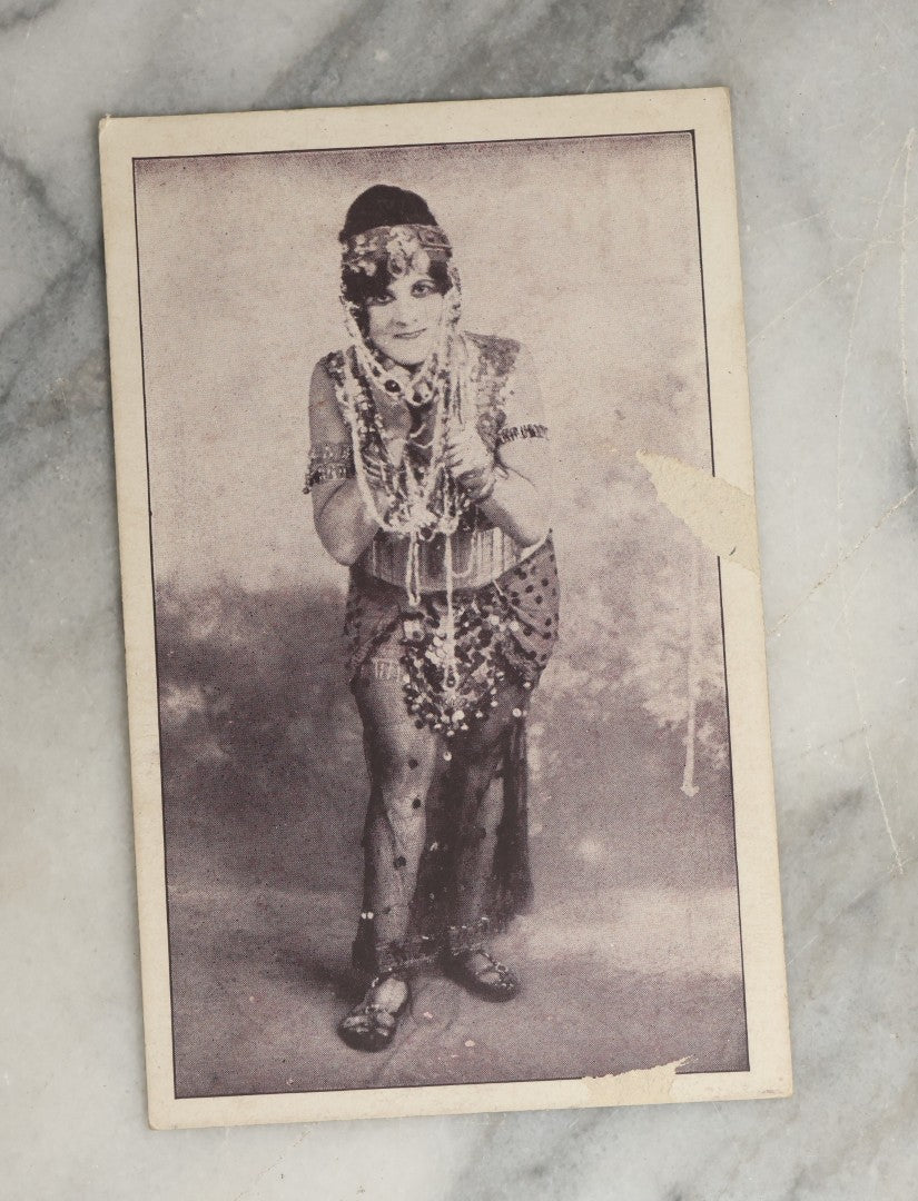 Lot 082 - Grouping Of Ten Antique And Vintage Photographic Postcards Of Women Including Gypsy Woman, Woman In Mask, "Are You Game," Etc., (Grouping B)