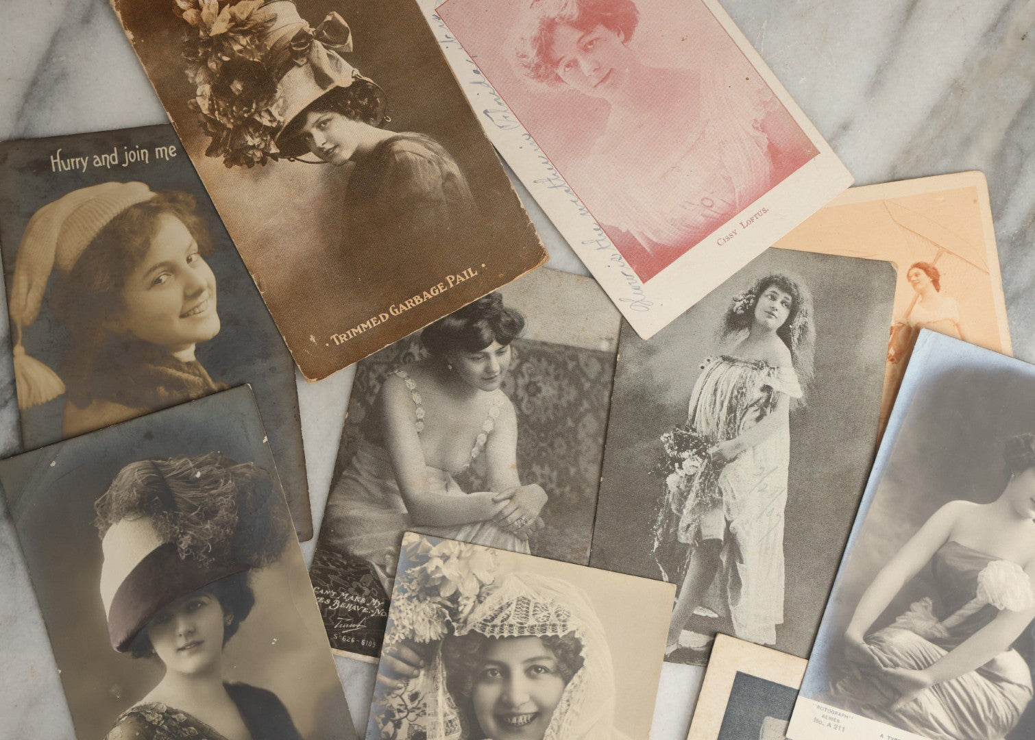 Lot 084 - Grouping Of Ten Antique And Vintage Photographic Postcards Of Women Including Woman In Garbage Pail Hat, French Beauty, "Hurry And Join Me," Etc., (Grouping D)